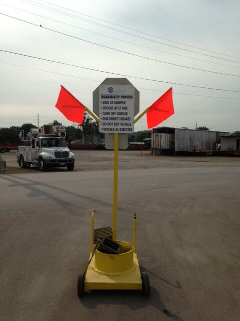 stop sign with safety messages: turn off truck, remove emergency air line, stay in truck
