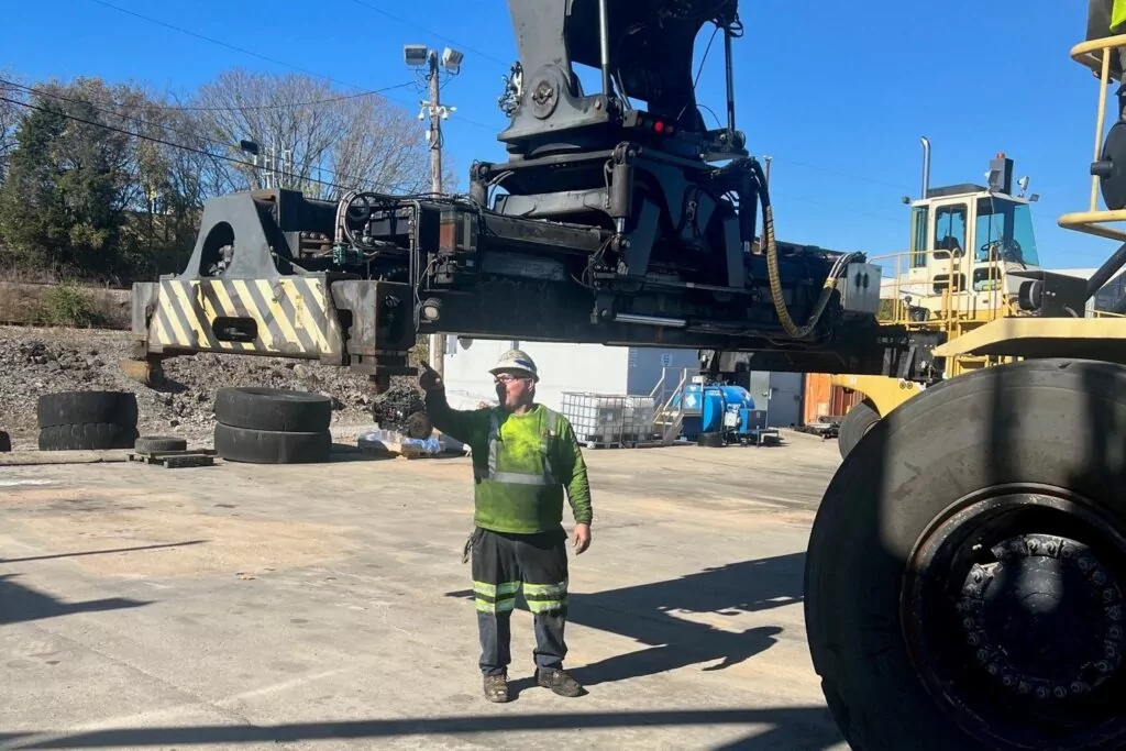 P&B employee performing mechanical repairs on lift equipment